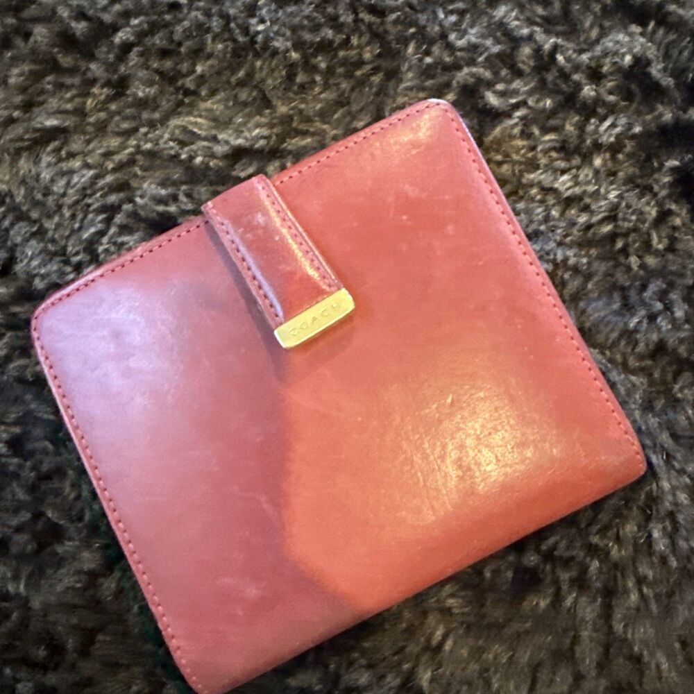 red Coach leather bifold wallet.